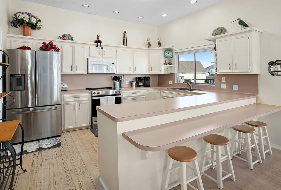 Kitchen has a lot of counter space. Breakfast bar sits four. 