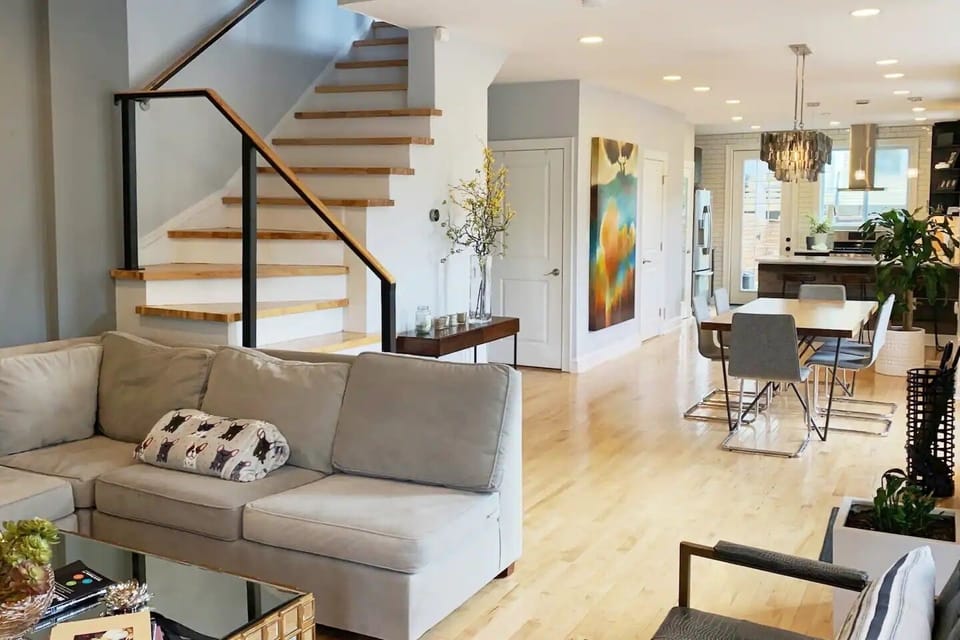 Comfortable L-shaped couch, two stylish chairs, 75-in flat-screen TV, fireplace.