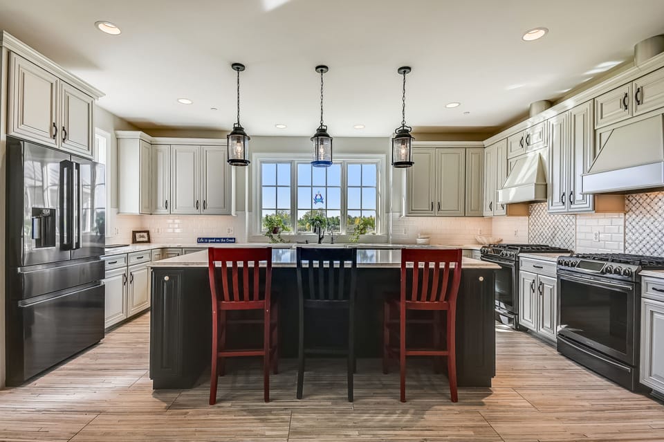 Spacious kitchen with quartz counter tops and a wine/coffee bar.