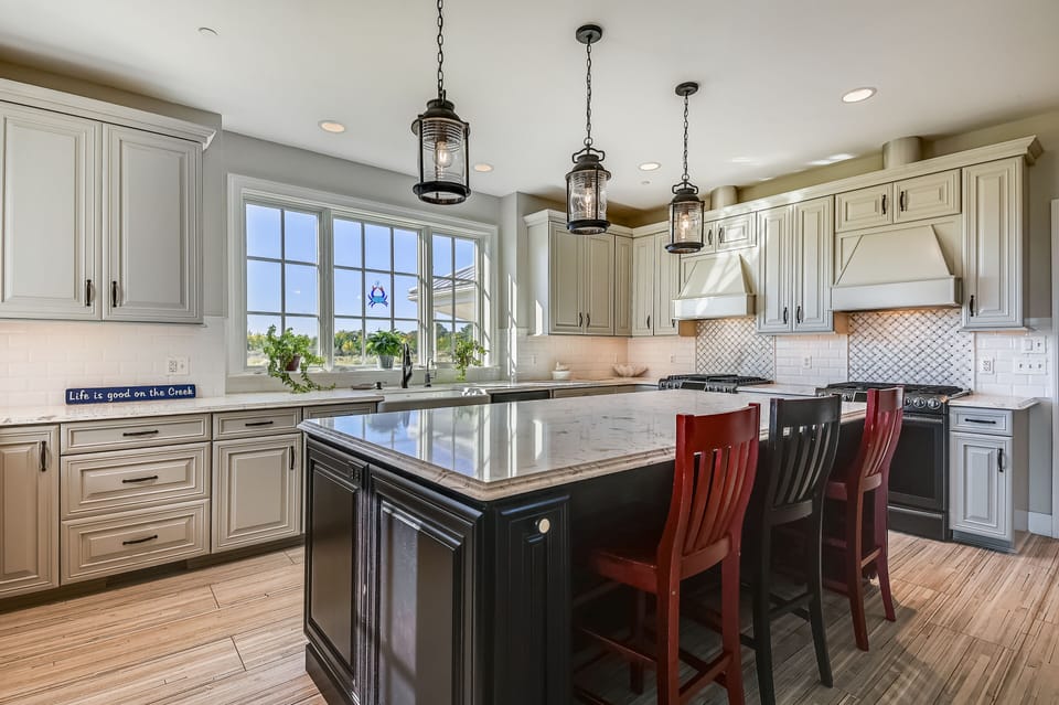 2 ovens and a beverage refrigerator under island.