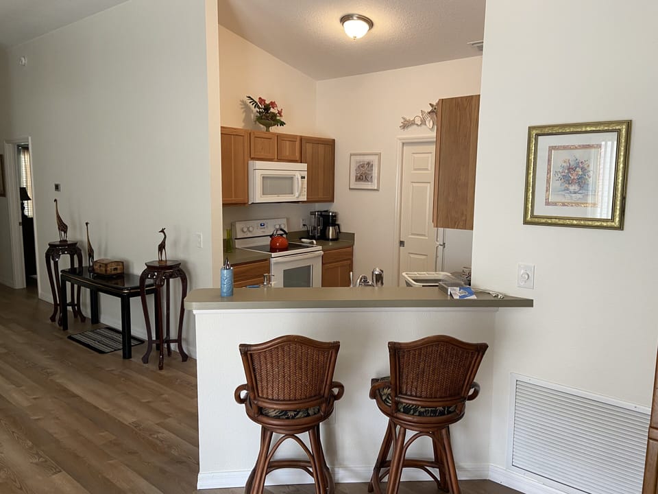 Kitchen with counter seating, a phone charging station, and a Keurig
