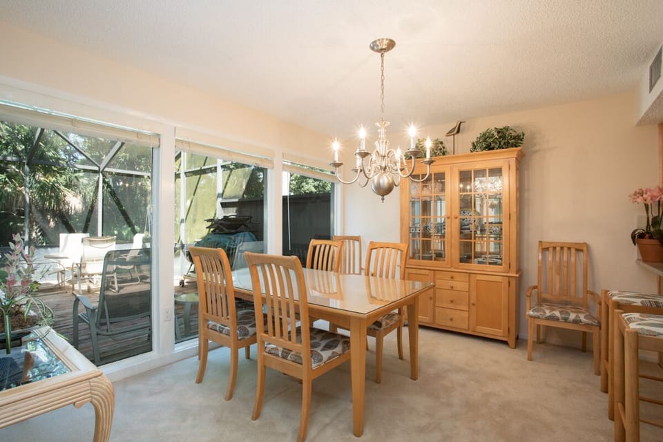 - Dine in style in this elegant space with seating for six and a glass door china cabinet
- Sparkling chandelier and full wall of windows bring natural light to every meal
- Sliding doors lead to the patio for easy indoor outdoor dining