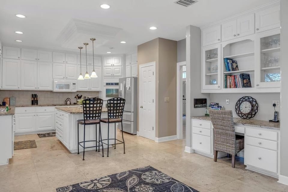 - Spacious all white kitchen with double islands, breakfast bar seating, and pendant lighting
- Enjoy easy meals or prep snacks with full size appliances and extra storage
- Includes built in workspace to plan your day or catch up on emails