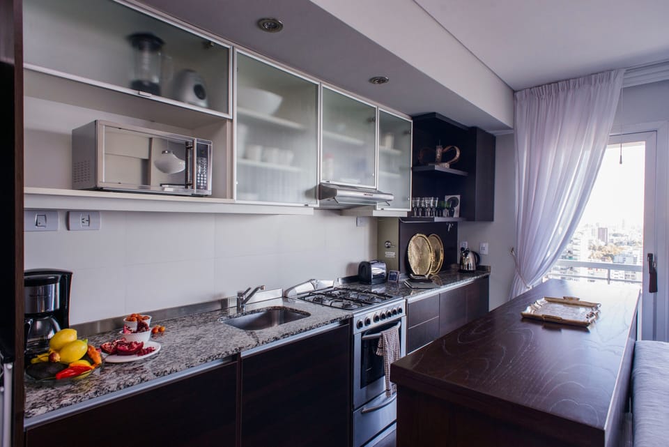 Fully-stocked modern kitchen with coffee machine, toaster, kettle and microwave