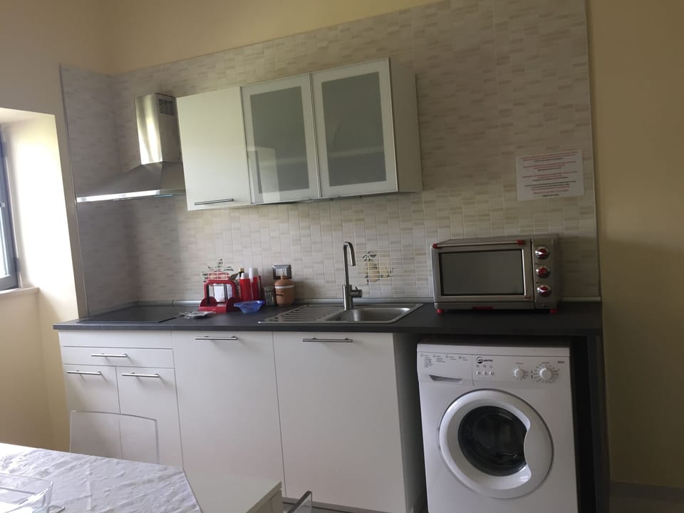 Kitchen with induction hob, oven, fridge and as fab photo washing machine.