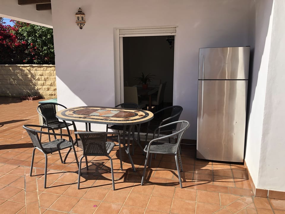 Outside dining area , fridge, seating and BBQ 