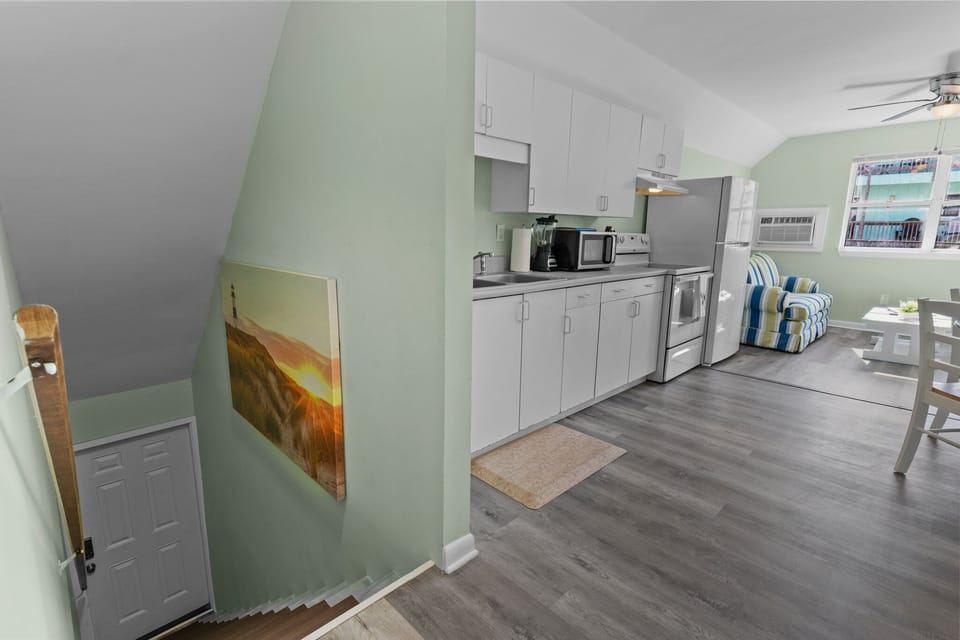Your fully equipped kitchen features modern appliances and opens to a bright dining area, perfect for home-cooked meals during your stay.