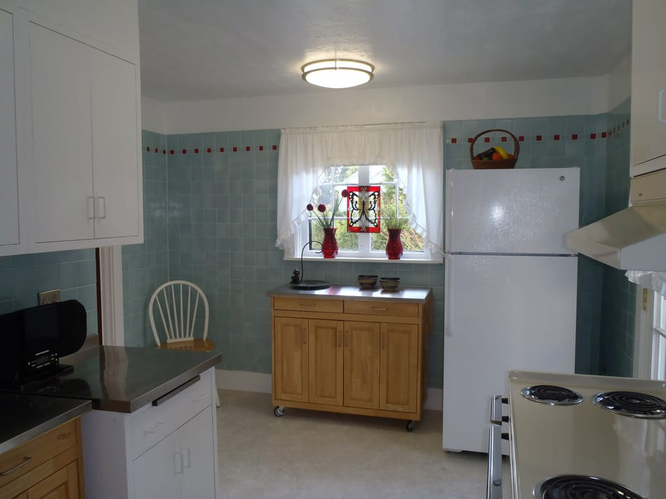 Kitchen - Cute bright and plenty of cupboard space with door to large deck