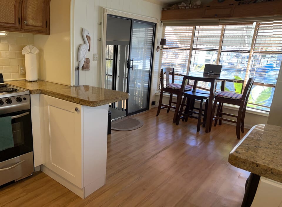 Upper level living room 2 with kitchen.
Pocket door to bedroom.