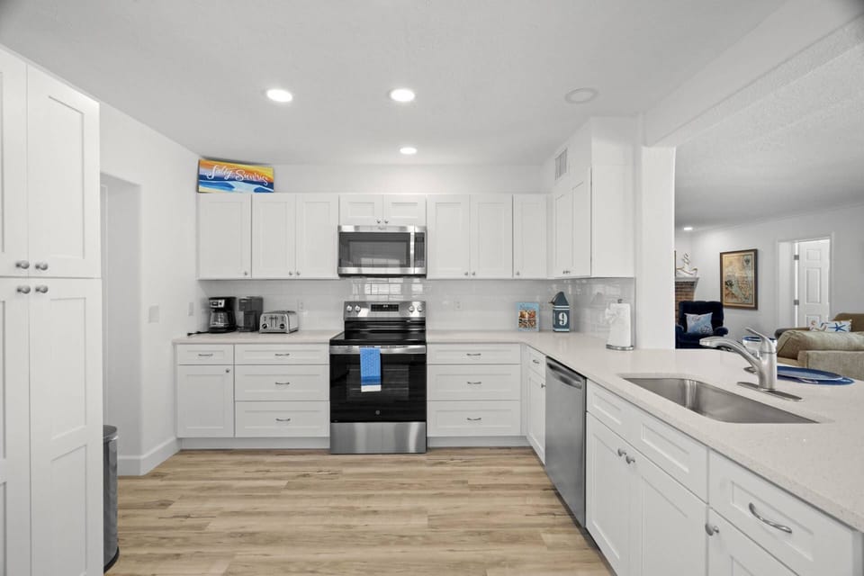 Newly Updated Kitchen with Stainless Steel Appliances and Breakfast Bar