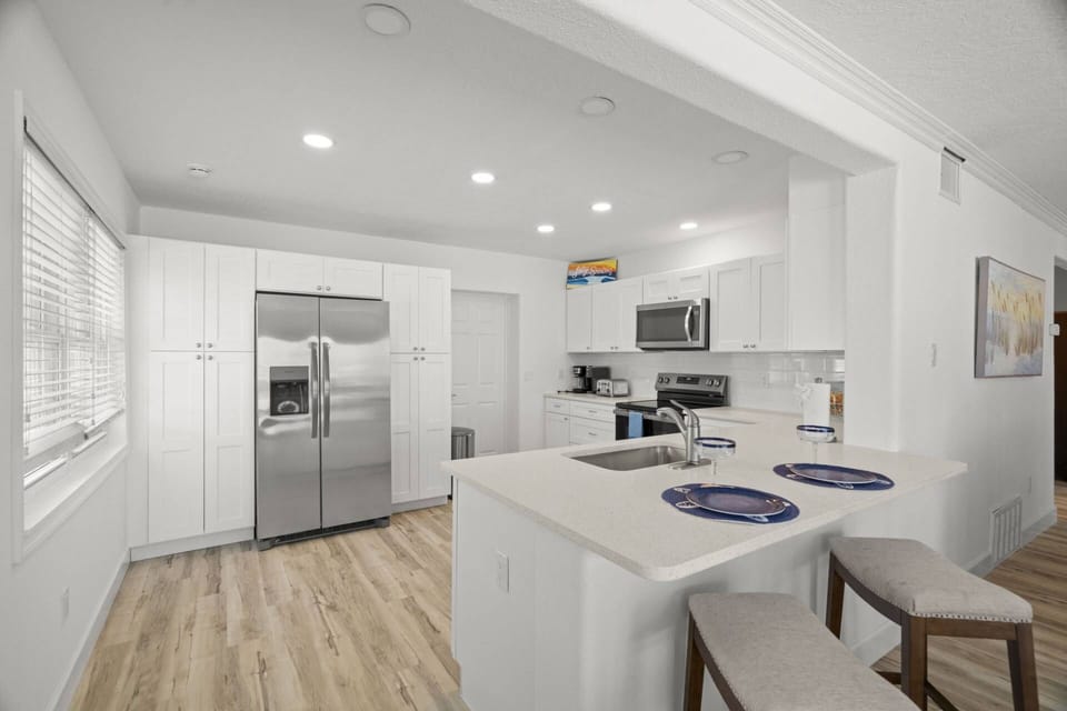 Newly Updated Kitchen with Stainless Steel Appliances and Breakfast Bar