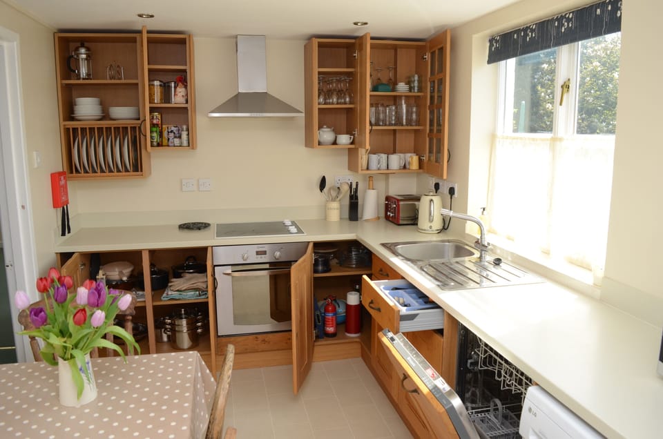 Kitchen showing cupboard contents