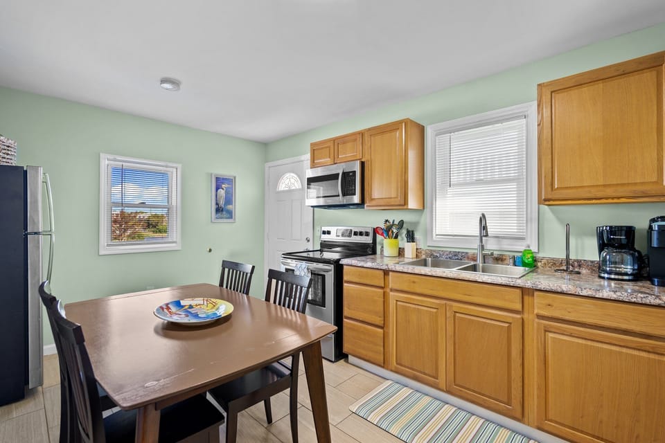 Cook your favorite meals in this bright, fully-equipped kitchen with modern appliances and granite countertops.