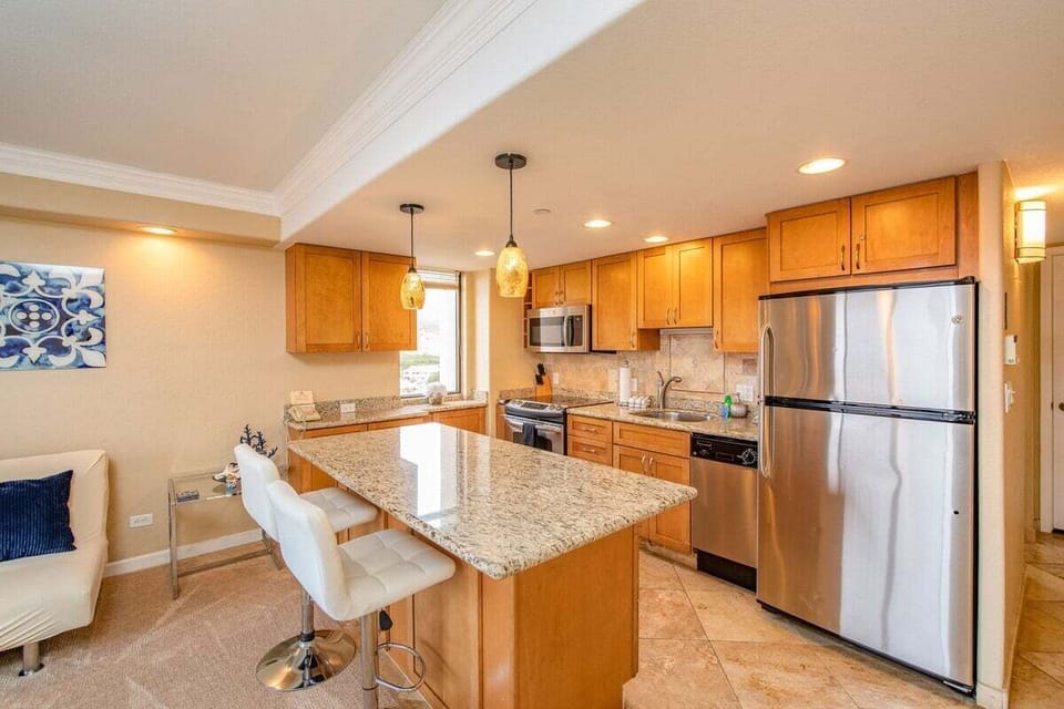 Fully equipped kitchen with granite countertop and stainless steel appliances