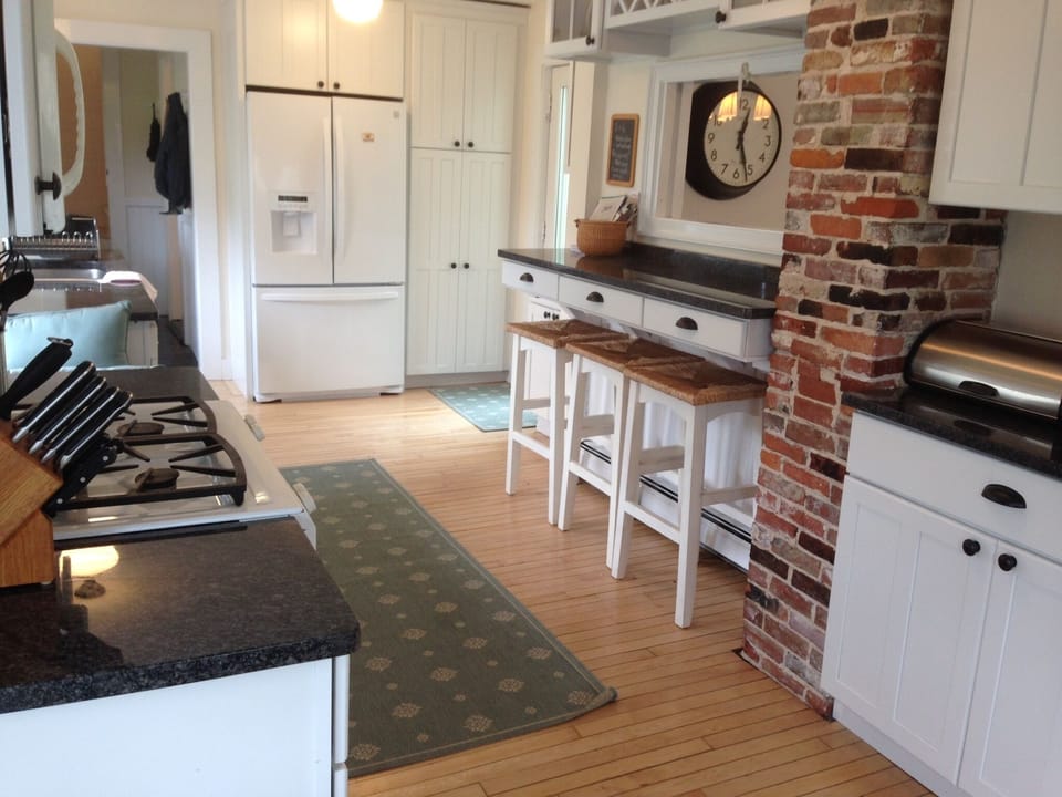 Newly remodeled kitchen with granite countertops, breakfast bar, gas range
