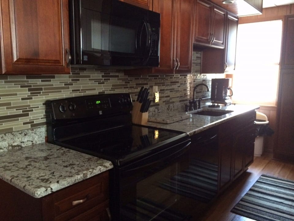 3rd floor kitchen - granite counter tops and cherry cabinets