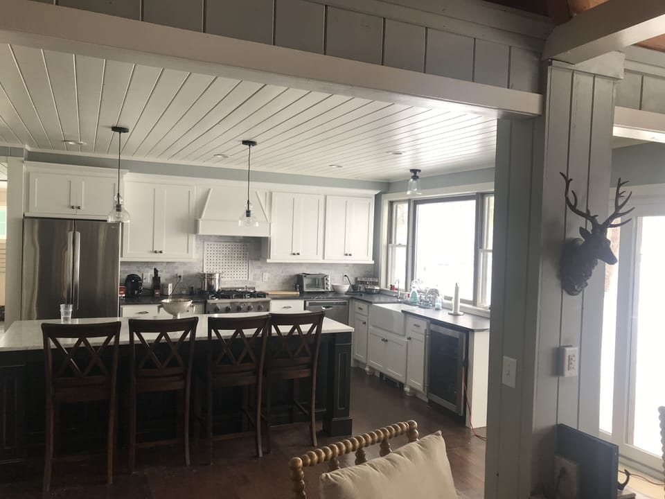 Gourmet kitchen with  commercial gas range and stainless steel appliances. 