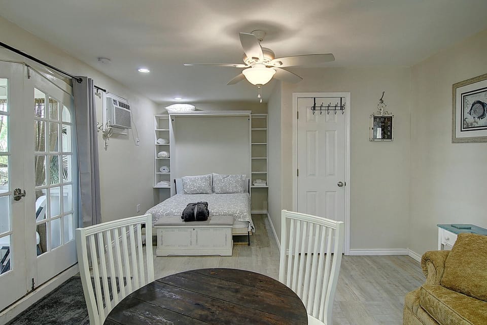 Your smart murphy bed transforms this bright studio from living space to bedroom instantly, maximizing comfort in every square foot.
