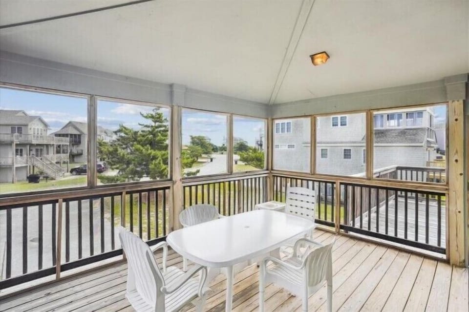Picture yourself savoring morning coffee or evening meals at your private screened porch, where coastal breezes and bright natural light create the perfect retreat after beach days.