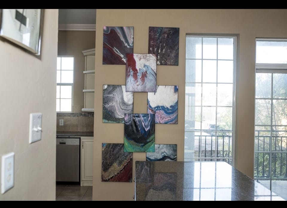 Artist Donated paintings from his collection so fun wall in the kitchen