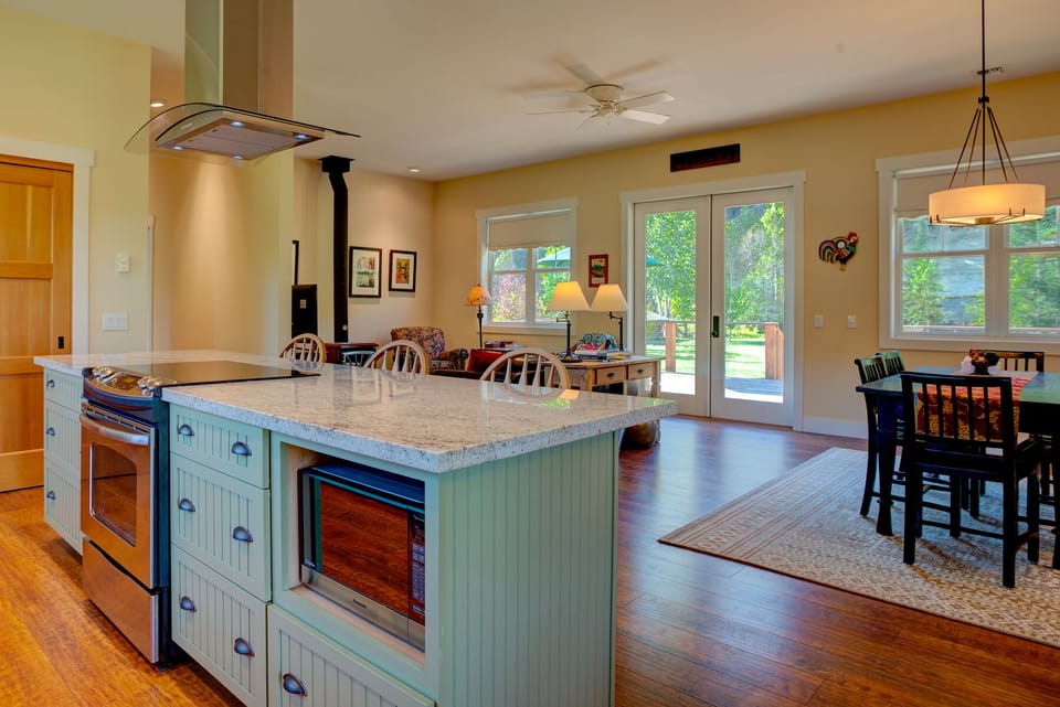 The sunny great room includes a kitchen dining, living and access to the deck. 
