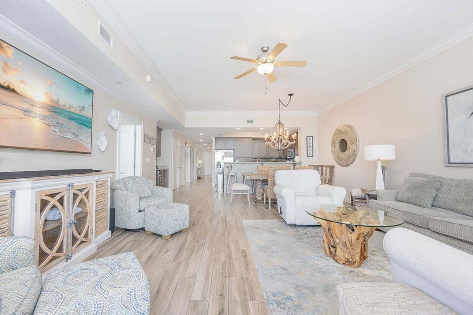 Unwind in the inviting living area, surrounded by airy decor and beach views, perfect for relaxation