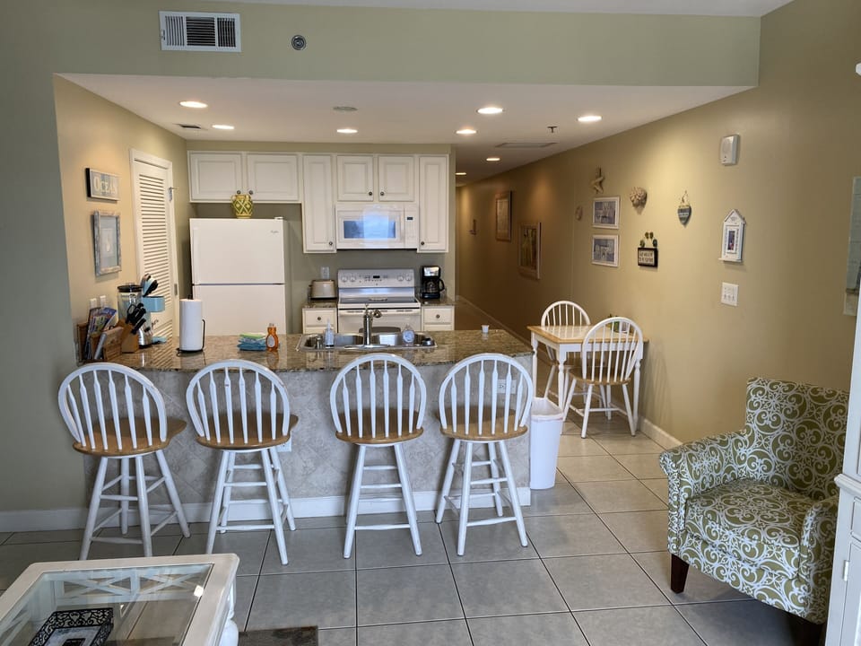 Fully stocked kitchen with breakfast bar 