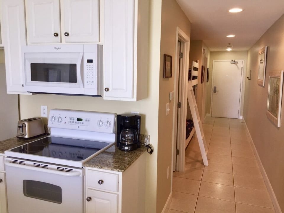 View of kitchen and entrance to hallway bathroom & bunkbeds