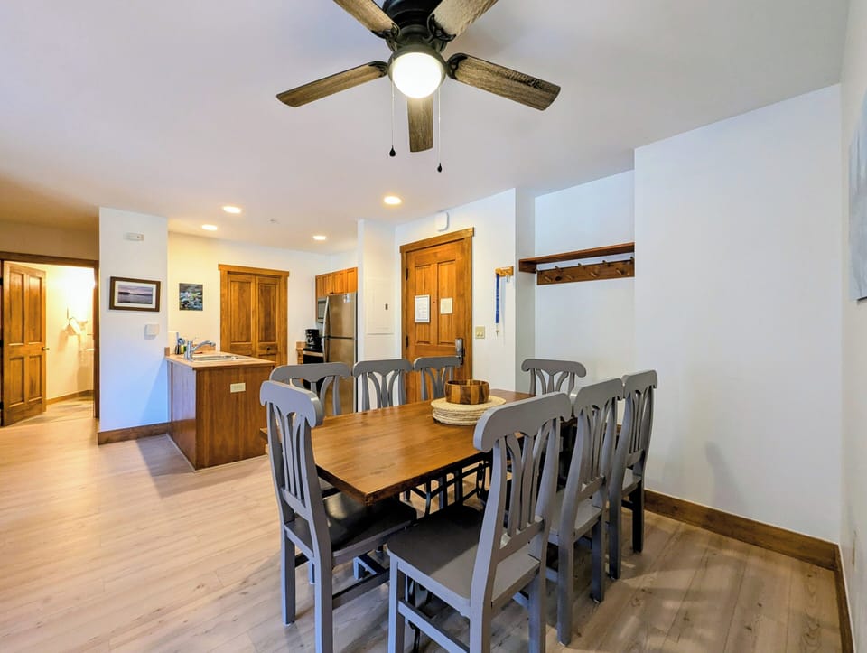 Gather around your spacious dining table for eight, where warm wood tones and modern amenities create the perfect setting for memorable meals together.