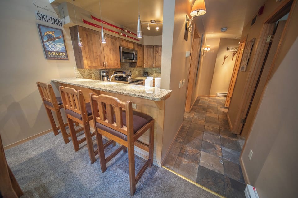 Fully equipped kitchen with bar stool seating