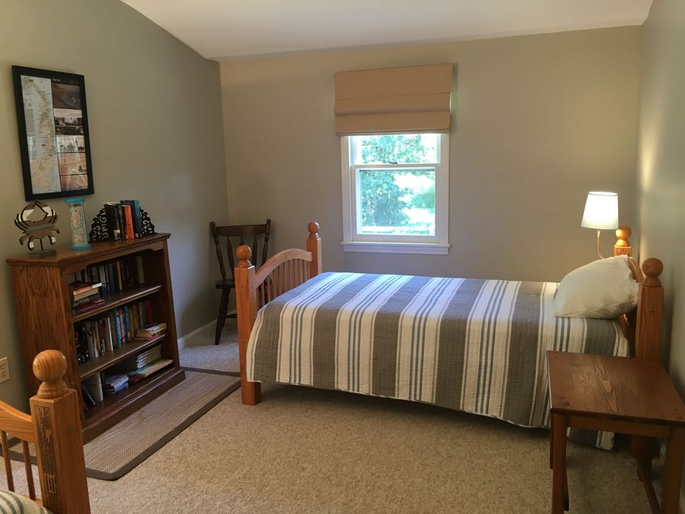 Large bedroom accommodates two guests in separate spaces.