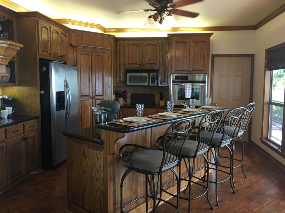 Upstairs kitchen. Bar seats 4 people. 