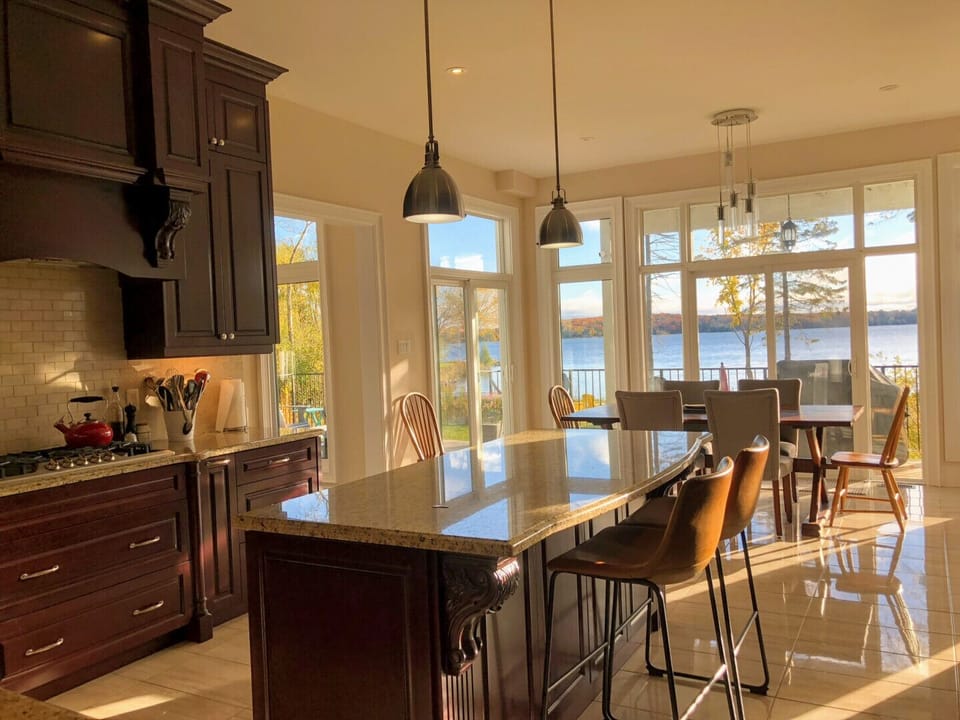 Bright and sunny kitchen with walk outs to deck and BBQs.