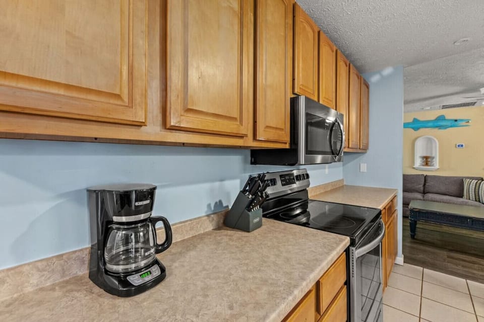 Large kitchen with stainless steel appliances. Fully-stocked and ready for you to whip up a meal for your group!