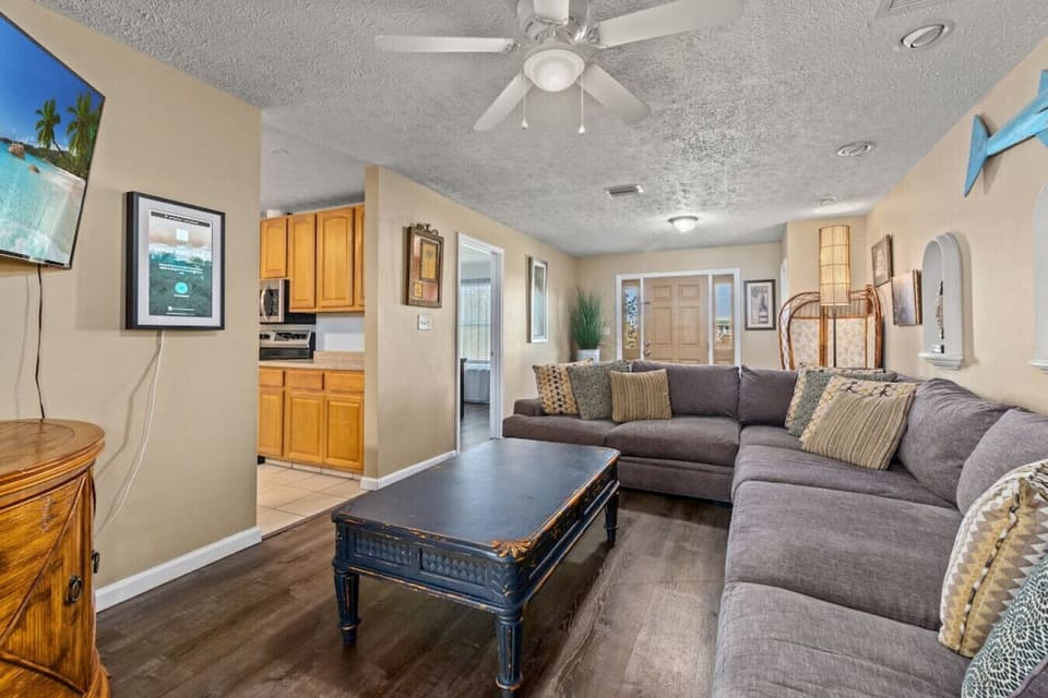 Comfy & cozy living room with lots of seating & smart Roku TV, pirate-y decor