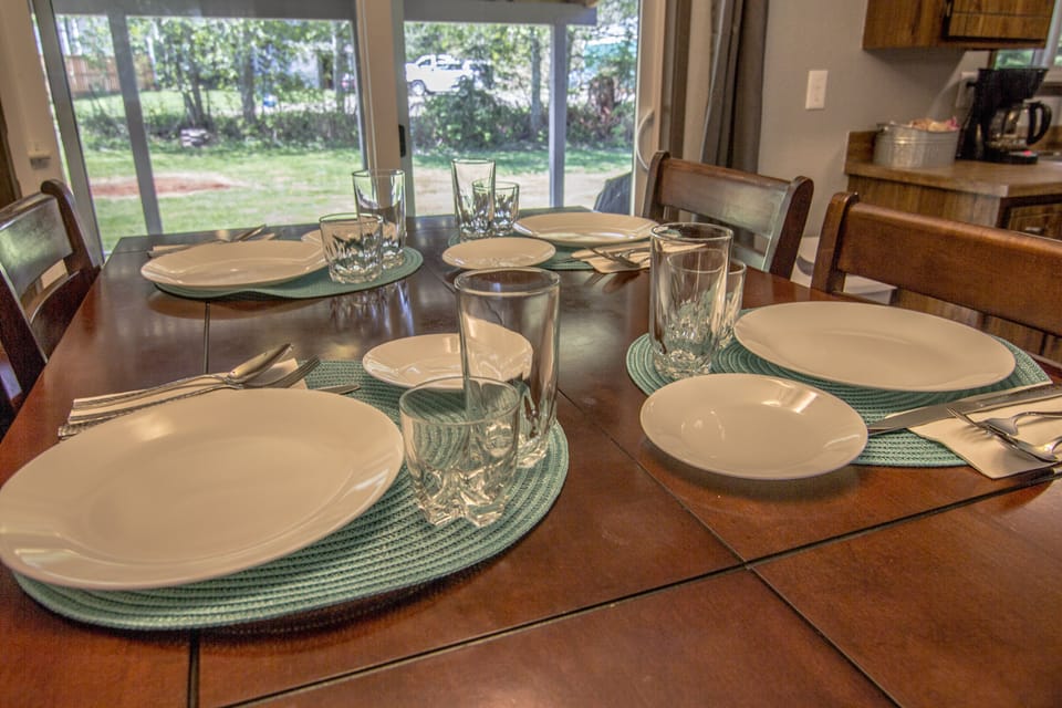 Pub height dining table (built in expansion leaf). Covered patio/backyard.