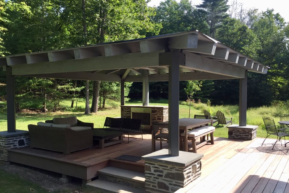 Weather-resistant outdoor room, with fireplace, ceiling fan and lighting