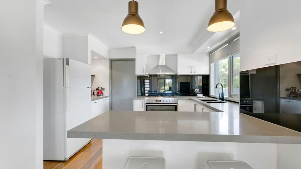 This fully equipped kitchen features ample storage space and counter spcae