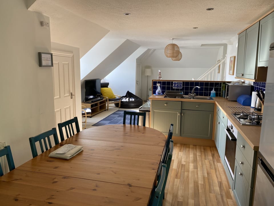 Kitchen/Dining Area, when cooking still join in & with seating for 10 persons!