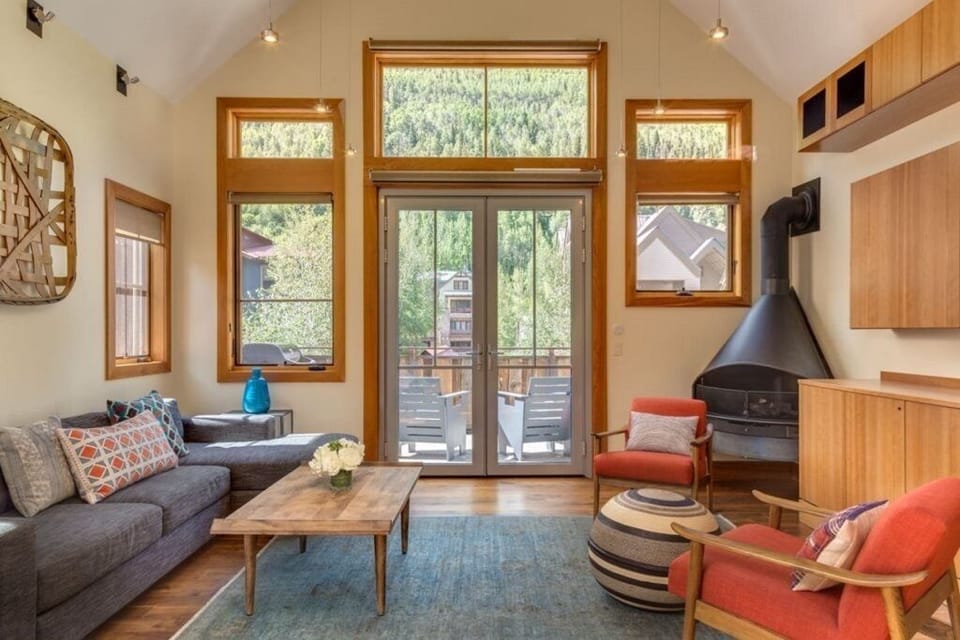 Bright, open living area with access to deck and views of mountains