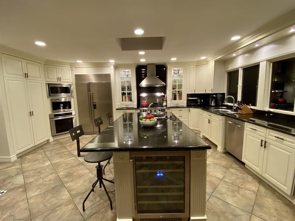 Kitchen island has a built in pasta maker and secondary sink and disposal.