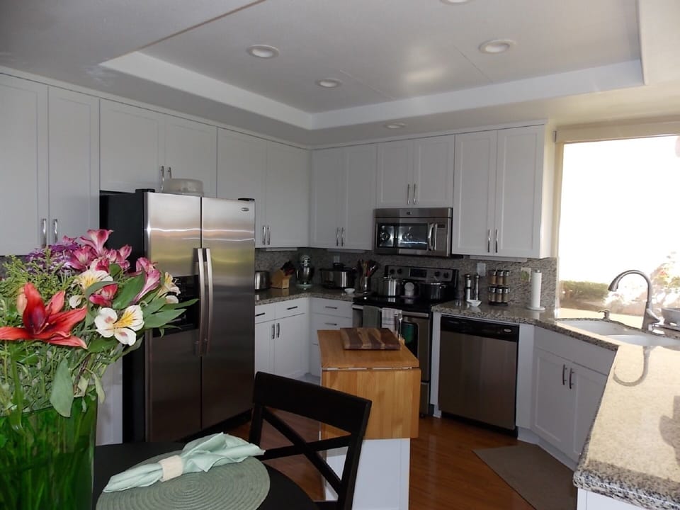  Kitchen with new lighting, granite countertops,  cabinets and dining set.