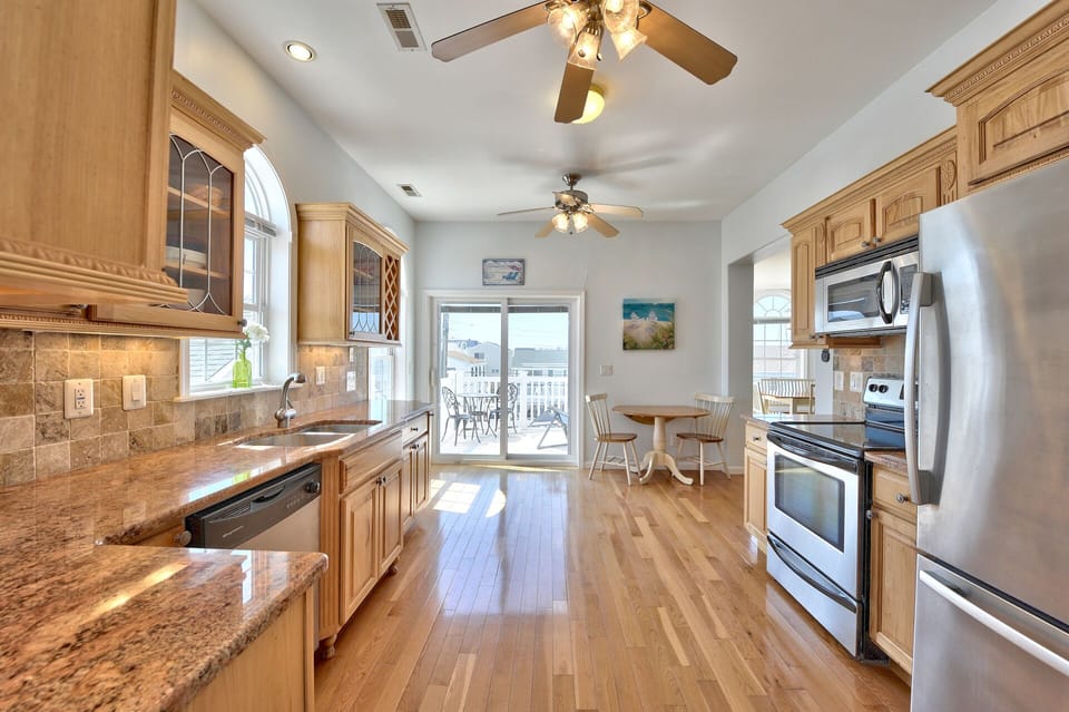 Fully stocked modern kitchen,  granite counters & stainless steel appliances!