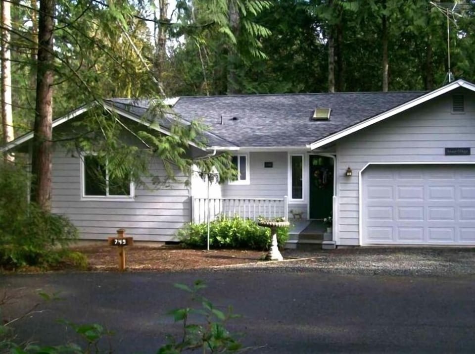 Island Magic -- nestled in the forest and across the street from view in Photo 1
