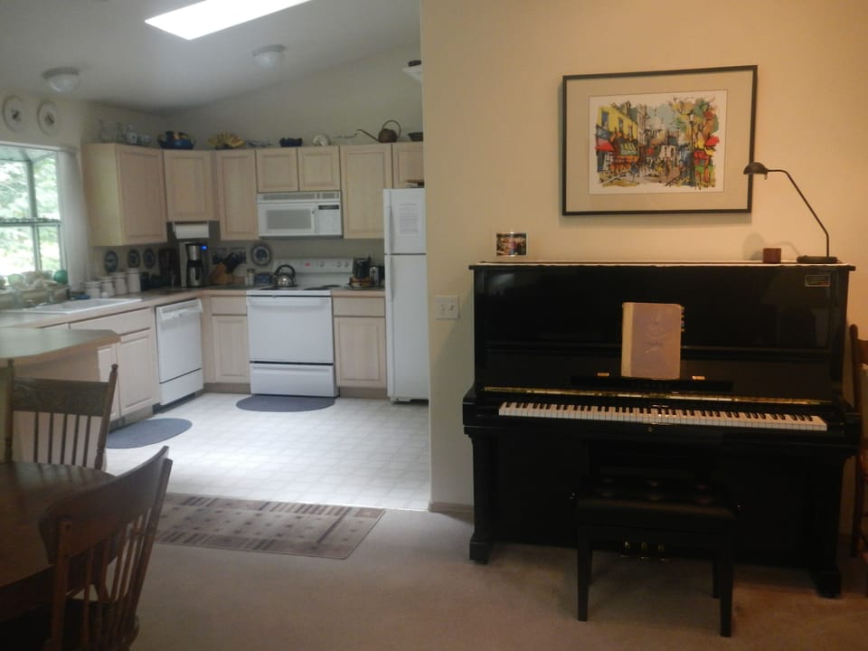 Kitchen, dining table, and professional grade Yahama U-3 piano in mint condition