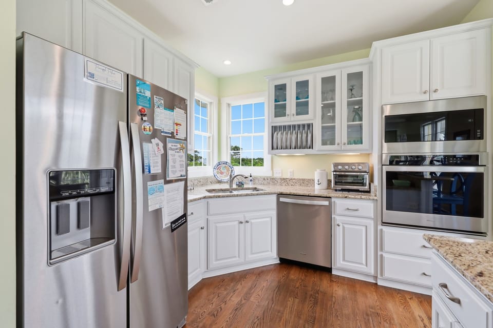 Your fully equipped kitchen features stainless steel appliances, granite countertops, and bright natural light—perfect for preparing family meals together during your stay.