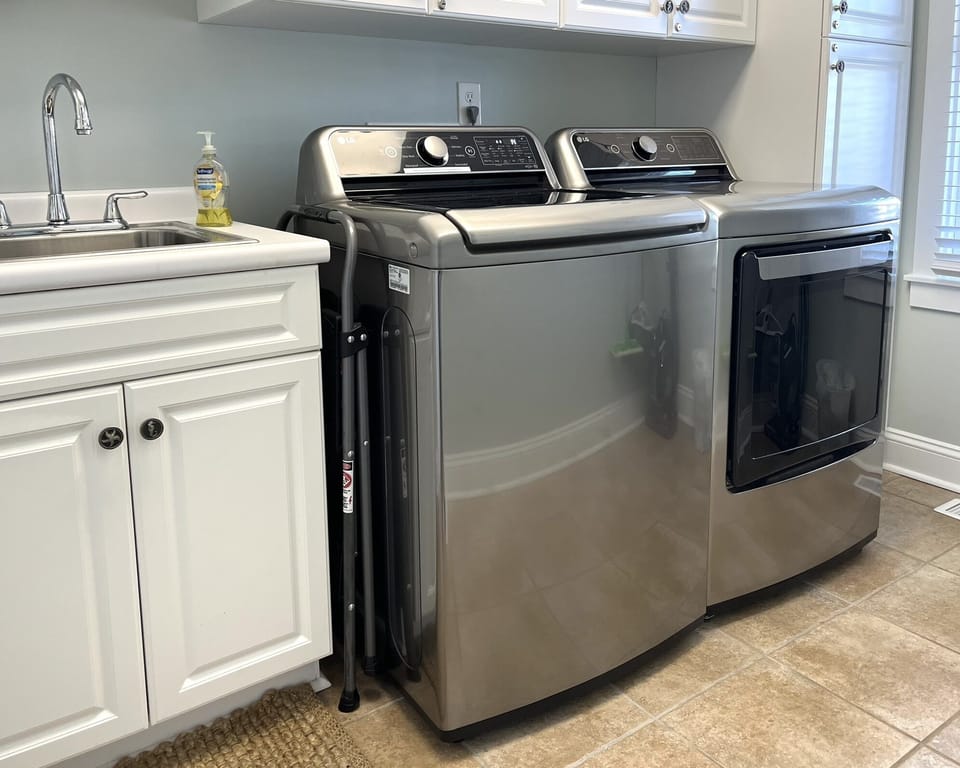 Laundry room on first floor with sink and full size washer & dryer