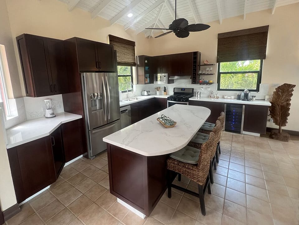 Kitchen with quartz counters, oversized island & beverage center w/ wine fridge 