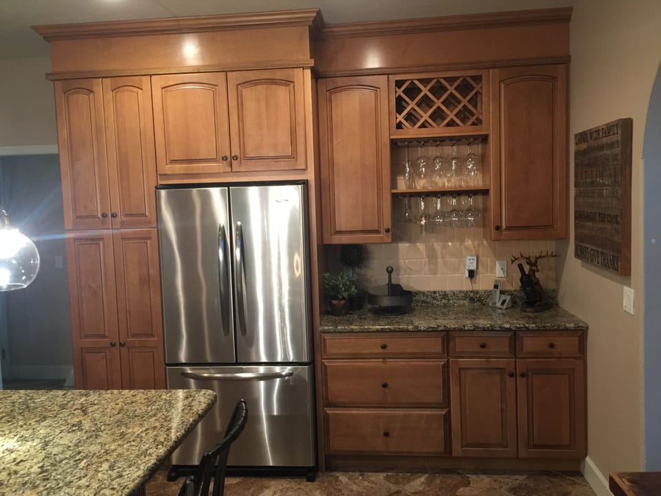 Custom cabinets with large stainless refrigerator