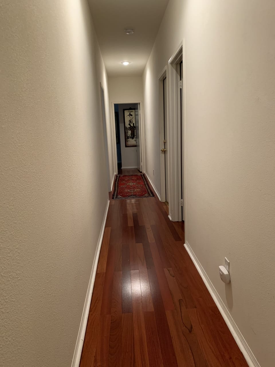Hallway looking to the  two guest rooms and shared bath
